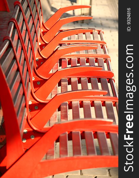 The detail of the red iron benches on the tram stop Chaplin sqaure, Barrandov district, Prague, Czech republic. The detail of the red iron benches on the tram stop Chaplin sqaure, Barrandov district, Prague, Czech republic.