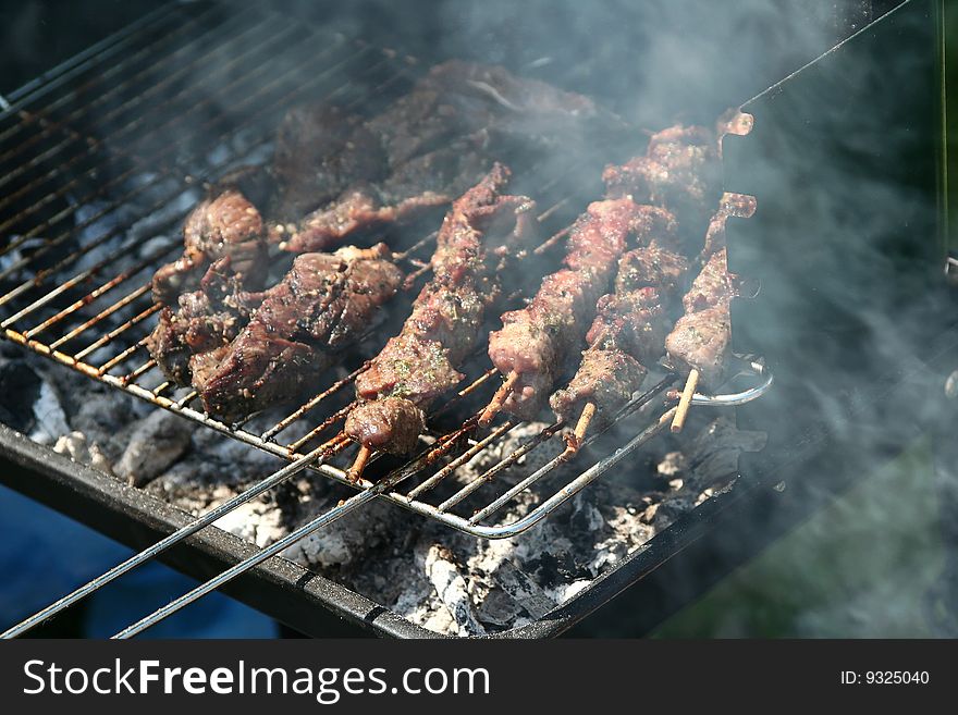 Sausages and chicken kebabs on a barbecue. Sausages and chicken kebabs on a barbecue