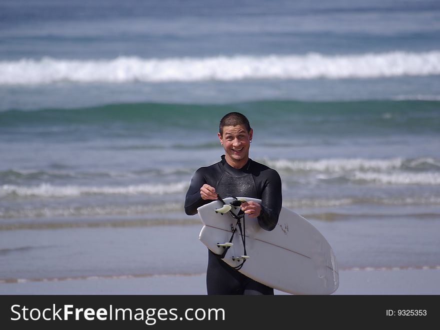 Smiling surfer on the beach