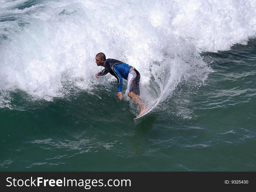 Young man in a wetsuit surfing. Young man in a wetsuit surfing