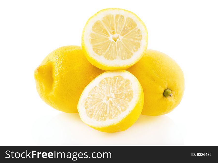 Lemon, two whole ones and one in half on a white background. Lemon, two whole ones and one in half on a white background.