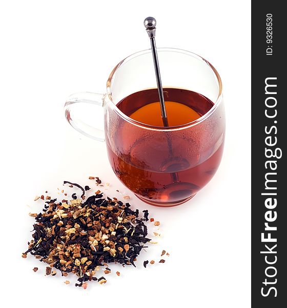 Glass of tea with some dried tea next to the glass on a white background. Glass of tea with some dried tea next to the glass on a white background.