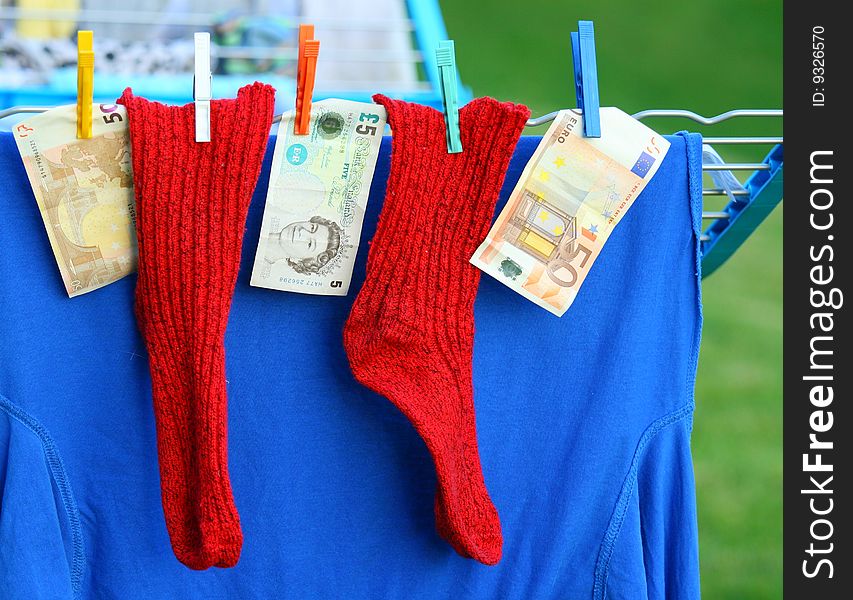 Two red socks and some banknotes. Two red socks and some banknotes