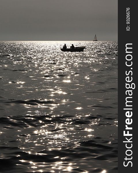Silhouette of two fishermen in the boat. Silhouette of two fishermen in the boat