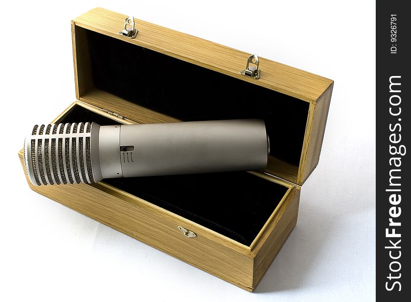 Studio microphone in a wooden case on a white background