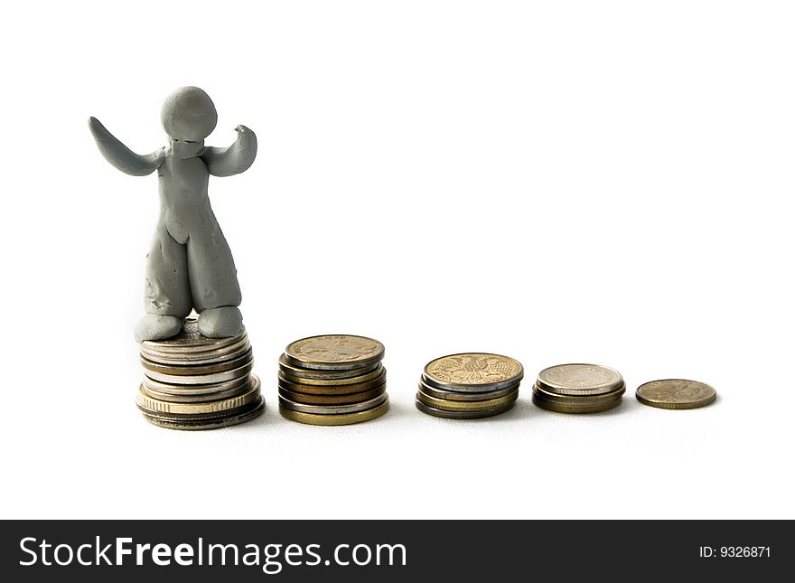 Plasticine figure and columns of coins. Plasticine figure and columns of coins