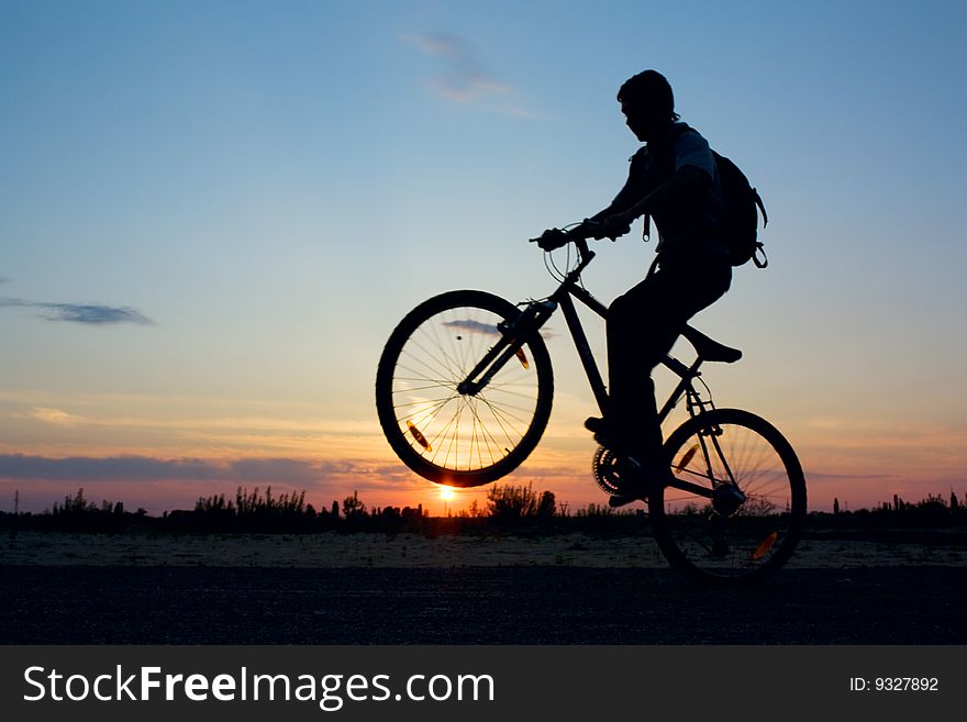 Boy on a bicycle in the sunset