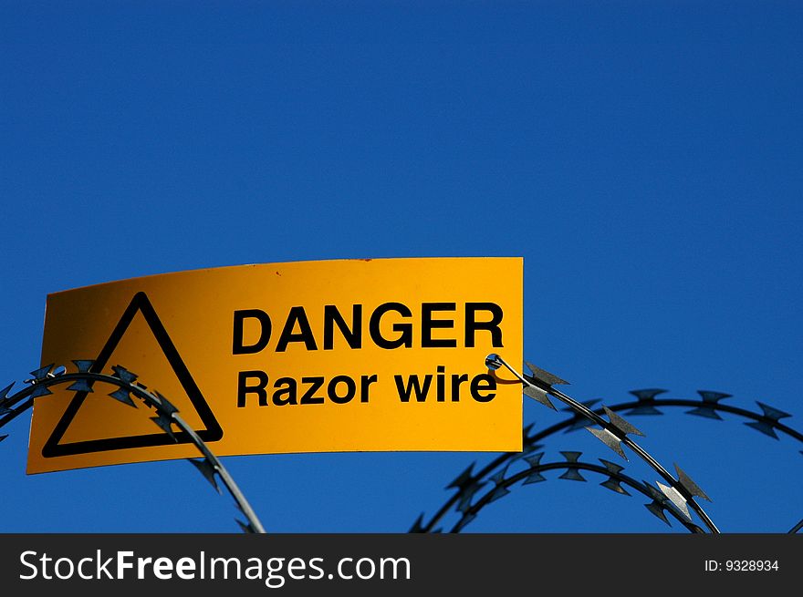 A warning sign on some razor wire