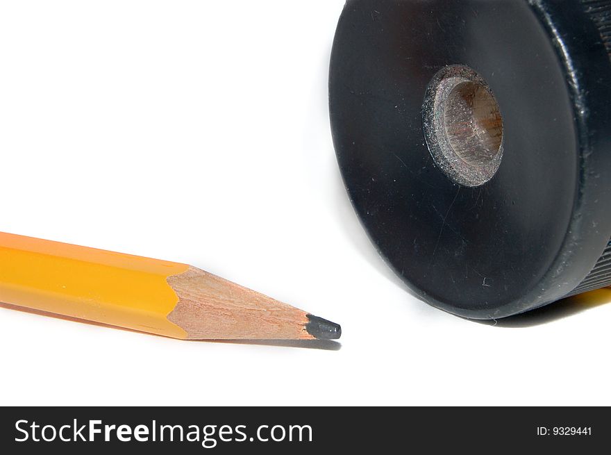 Picture of a yellow pen and a black shapener. Picture of a yellow pen and a black shapener