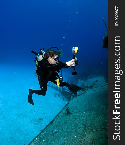 A Female Professional Underwater Photographer shooting the MV Tibbetts in Cayman Brac. A Female Professional Underwater Photographer shooting the MV Tibbetts in Cayman Brac