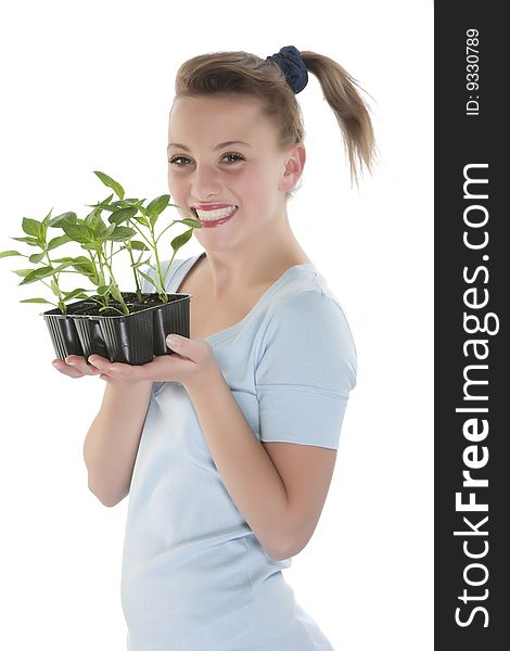 Beautiful smiling girl holding young plants