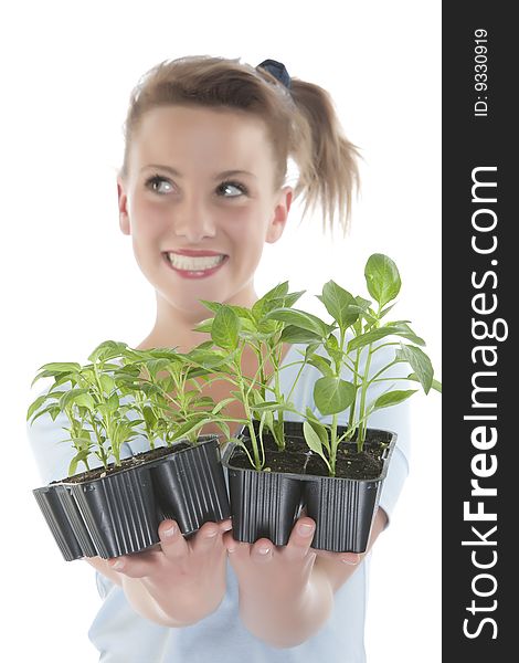 Beautiful smiling girl holding young plants