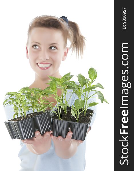 Beautiful smiling girl holding young plants