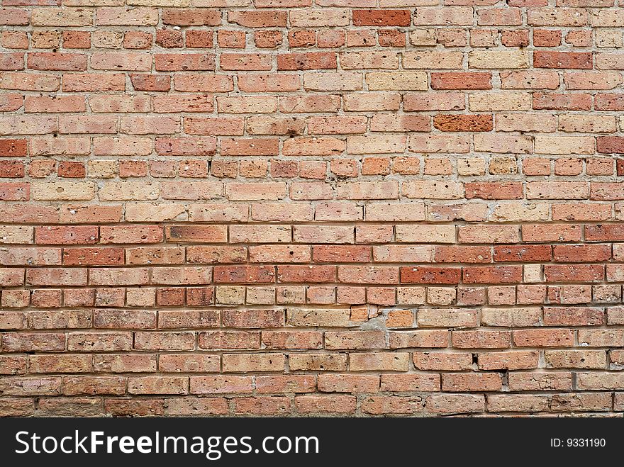 Old crumbling red brick wall background texture. Old crumbling red brick wall background texture