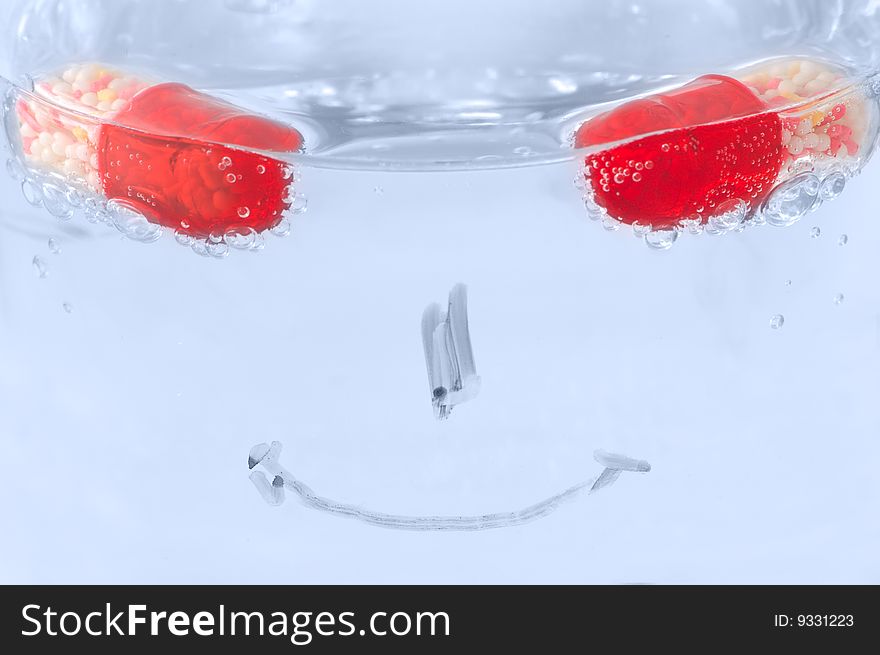 Take pills and get healthy again: concept with pills, water and smile