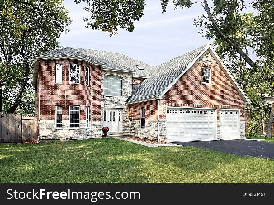 Brick home in suburbs with stain glass windows