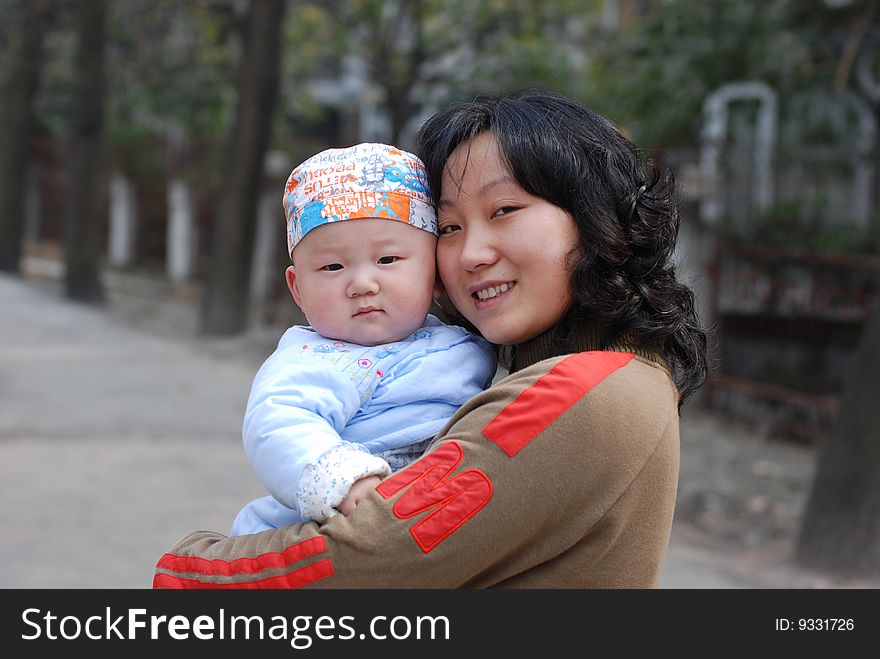 cute baby  with  mother