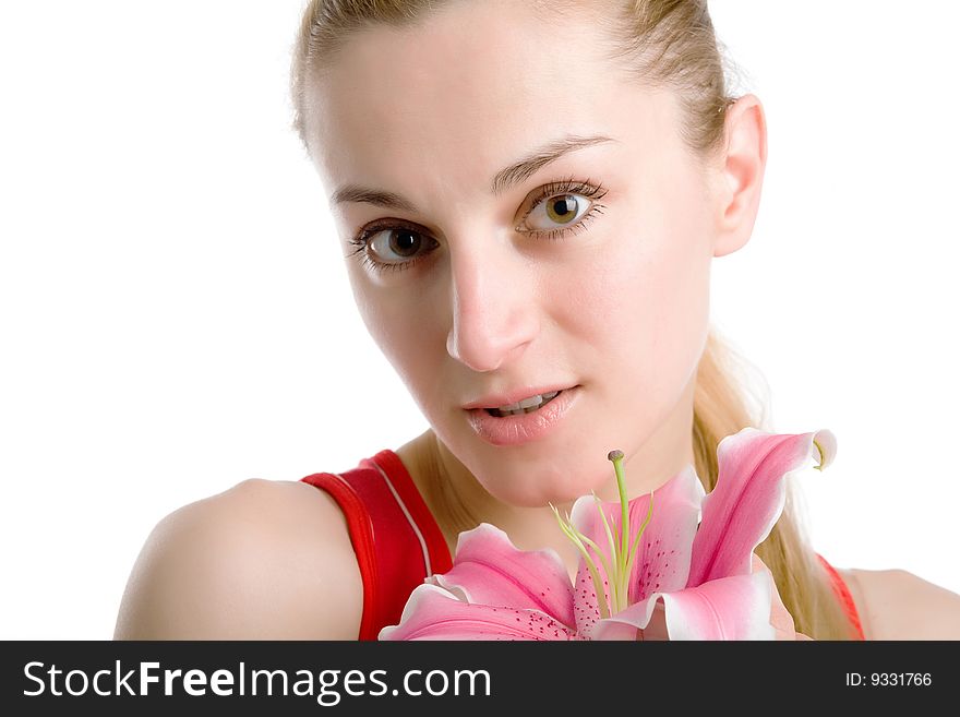 A portrait of a nice girl in red with a pink lily near her face on a white background. A portrait of a nice girl in red with a pink lily near her face on a white background