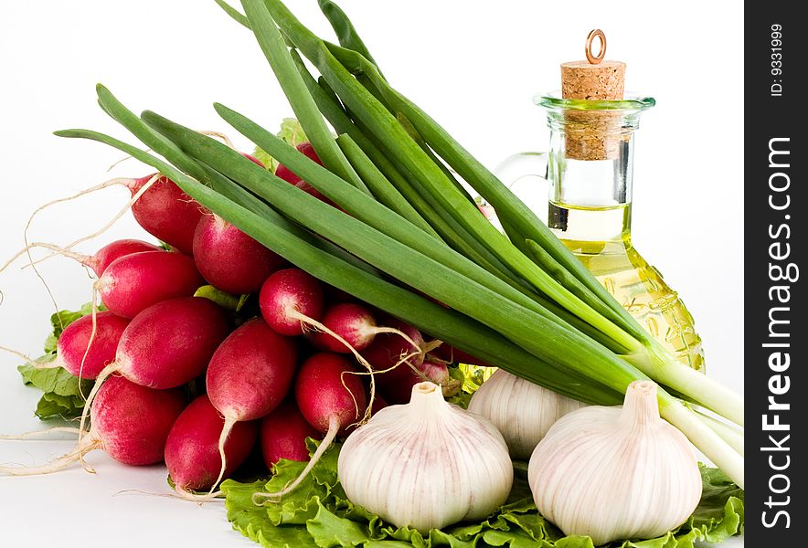 Green vegetables and a bottle of olive oil on the white background. Green vegetables and a bottle of olive oil on the white background