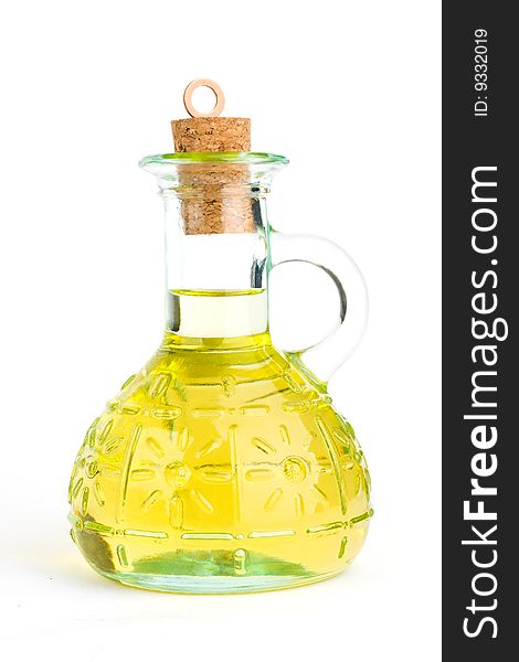 A corked up cruet with olive oil on the white background