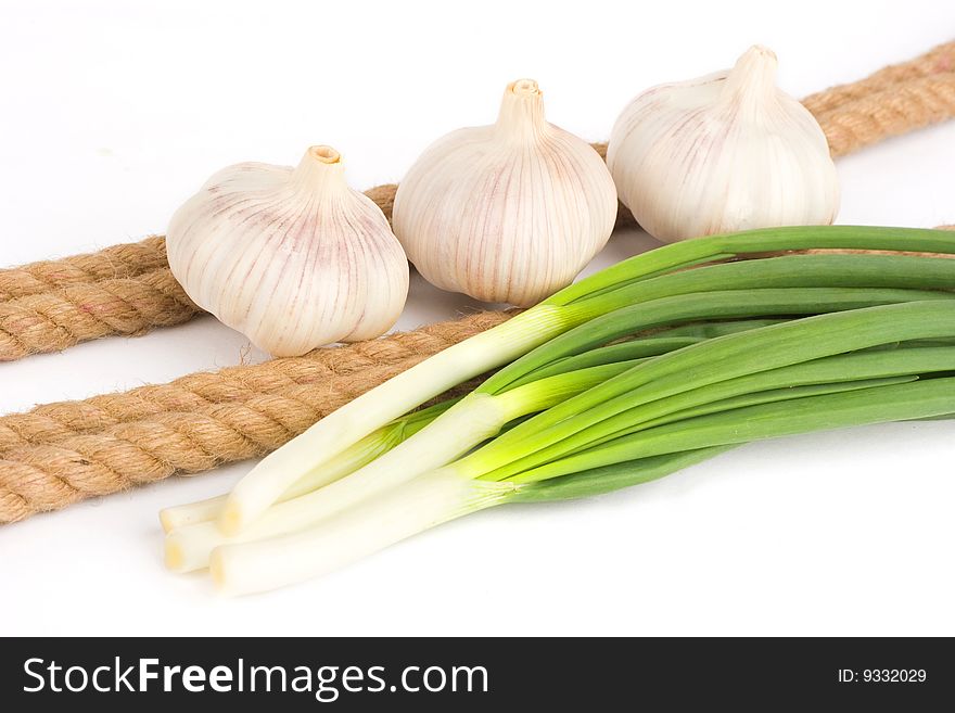 Vegetables near the rope on the white background