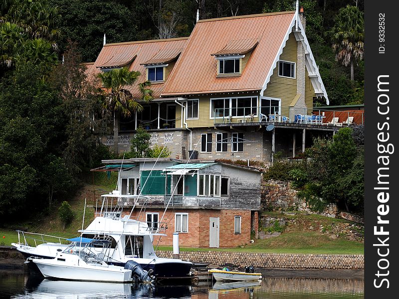 Waterfront home on river with boats