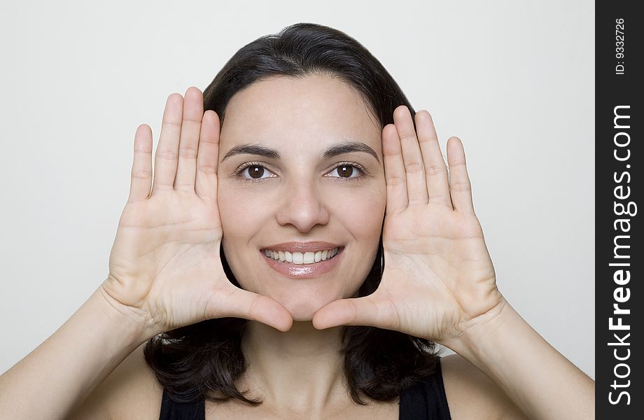 Young woman frame her face with palms. Young woman frame her face with palms