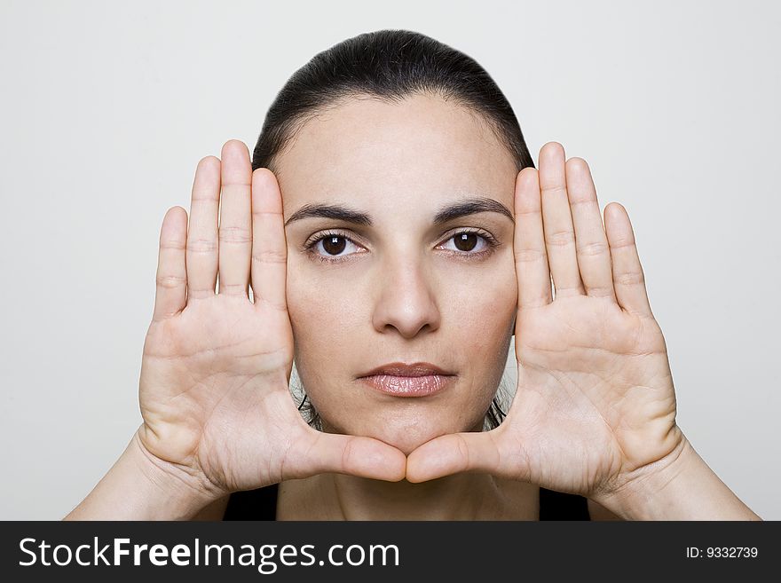 Young woman frame her face with palms. Young woman frame her face with palms