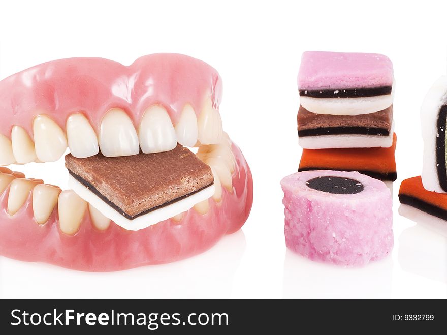 Dentures with candy isolated on a white background. Dentures with candy isolated on a white background.