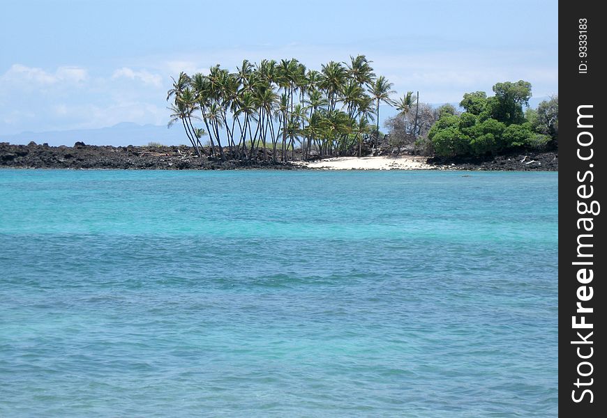 The lovely blue waters of Hawaii with a pocket of white sand beach. The lovely blue waters of Hawaii with a pocket of white sand beach.