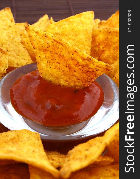 Salsa dip in a bowl on brown background