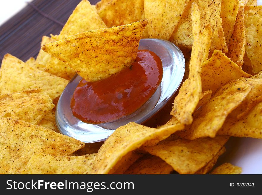 Salsa dip in a bowl on brown background