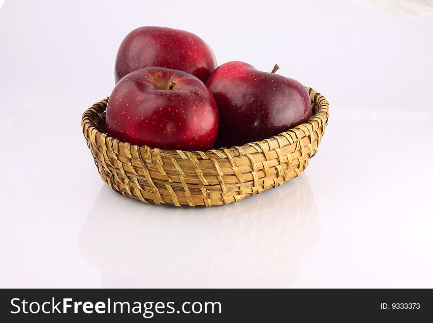 Red apples in a wicker plate