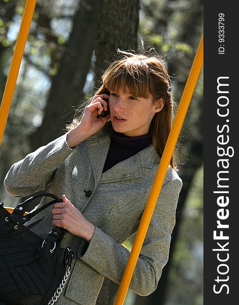 Fashion woman talking on a phone outdoor. Fashion woman talking on a phone outdoor