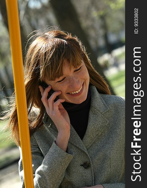 Causal woman talking on a mobile phone outdoor. Causal woman talking on a mobile phone outdoor