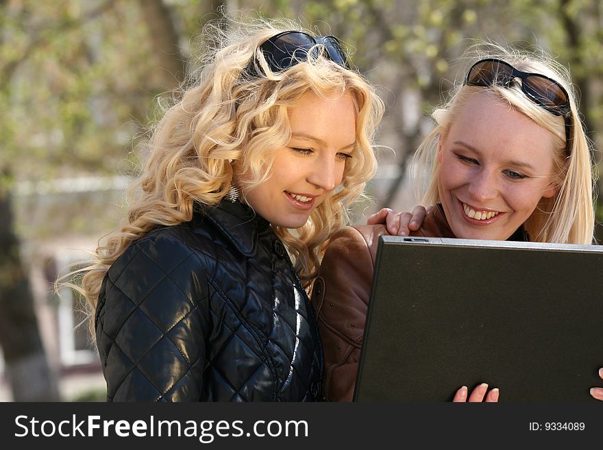 Women with laptop in park