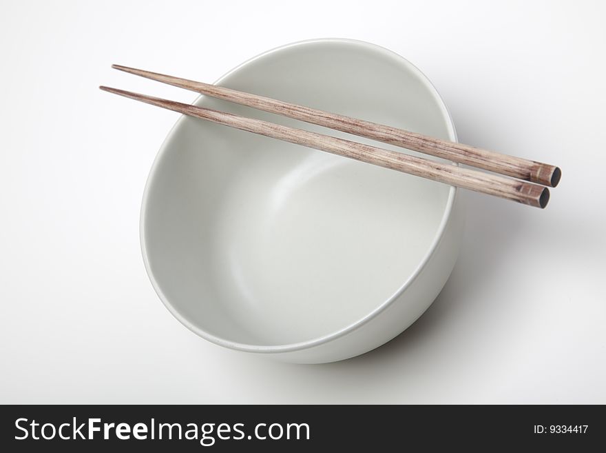 Closeup of chopsticks resting on a bowl. Closeup of chopsticks resting on a bowl