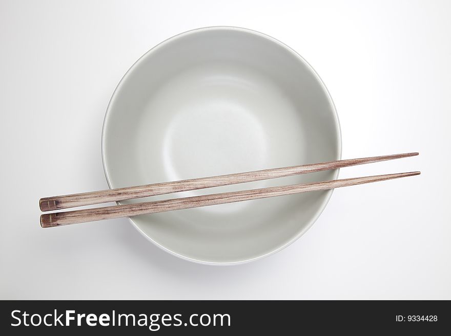 Closeup of chopsticks resting on a bowl. Closeup of chopsticks resting on a bowl