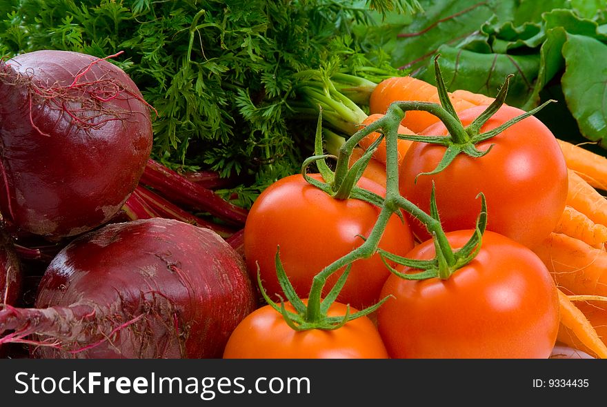 Close up image of market fresh beetroot, carrots and tomatoes. Close up image of market fresh beetroot, carrots and tomatoes.