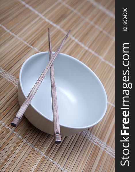 Closeup of chopsticks resting on a bowl. Closeup of chopsticks resting on a bowl