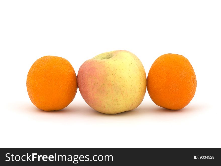 Apple and oranges on the white background