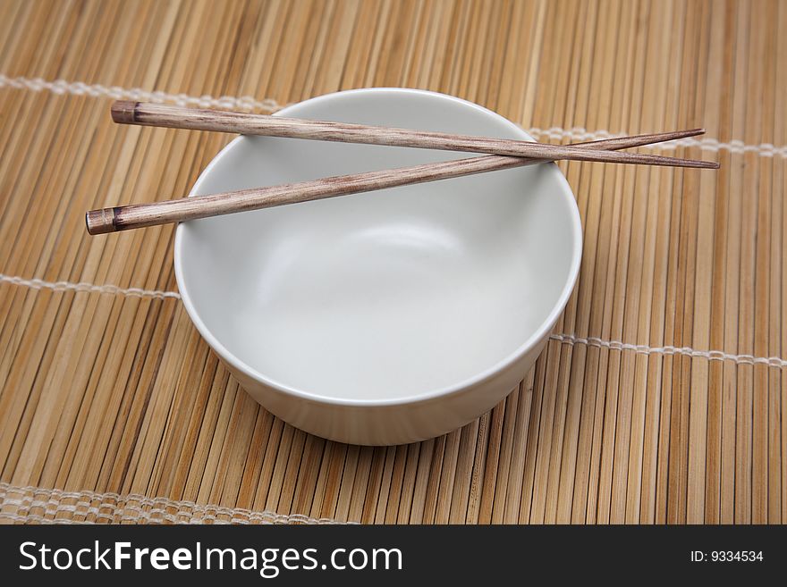 Closeup of chopsticks resting on a bowl. Closeup of chopsticks resting on a bowl