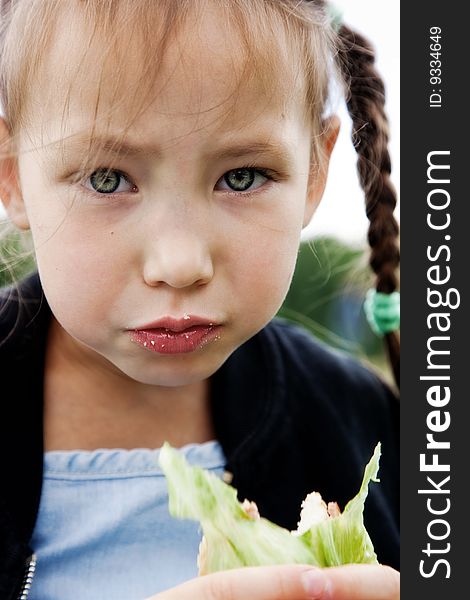 Little girl eats a sandwich