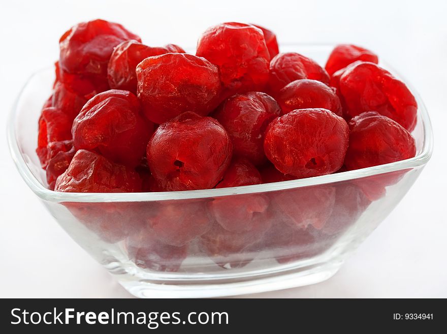 Dried up sweet cherry in a glass vase close up