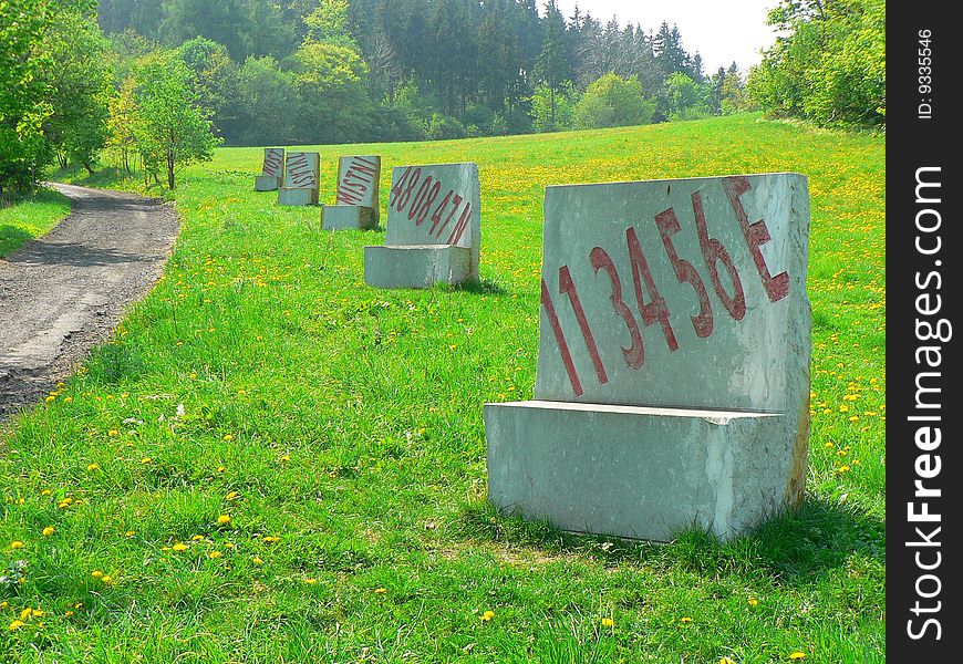 Line of stone chairs in a meadow