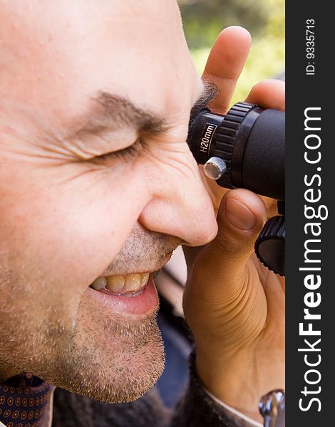 Scientist observing through his microscope. Scientist observing through his microscope