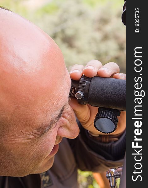 Scientist observing through his microscope. Scientist observing through his microscope