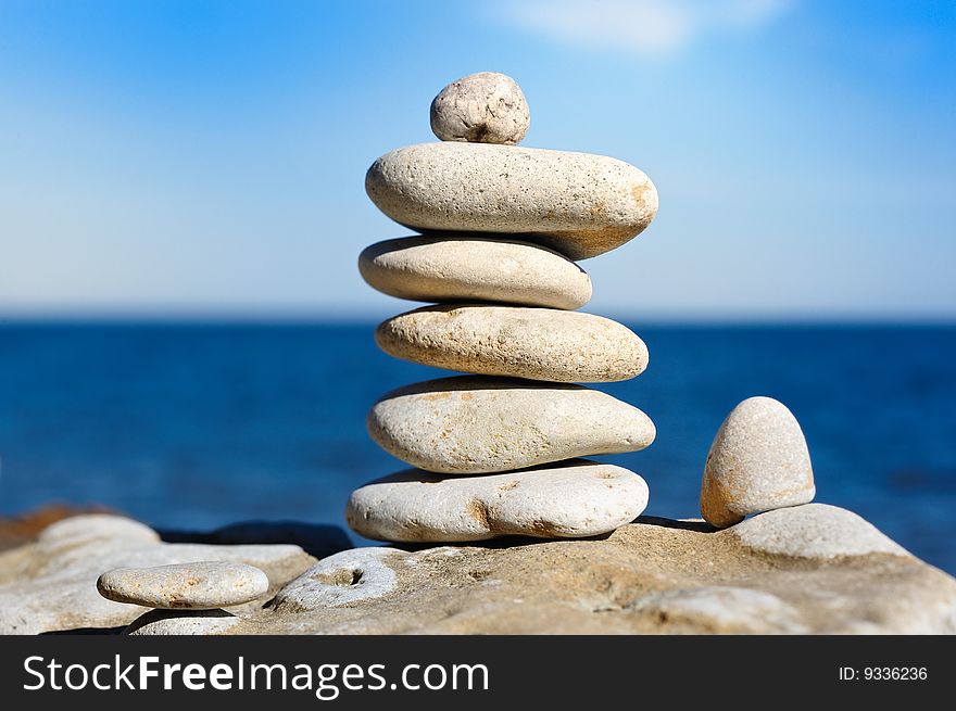 Several white pebbles one after another on a rock. Several white pebbles one after another on a rock