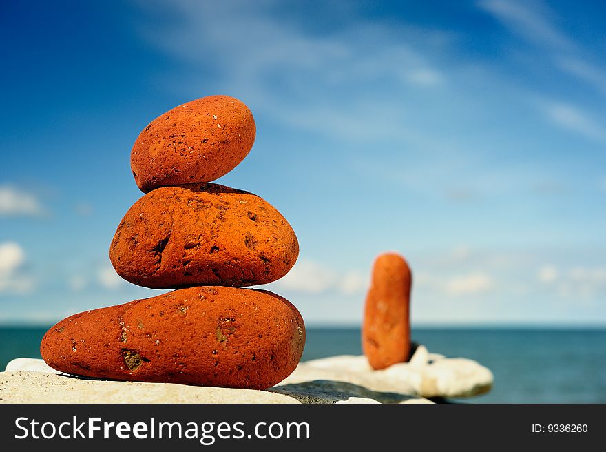 Several red pebbles one after another on a rock. Several red pebbles one after another on a rock