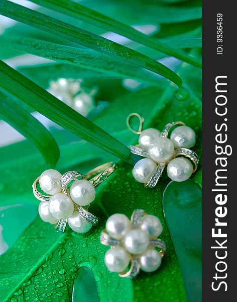 Pearl ornaments on green leaves